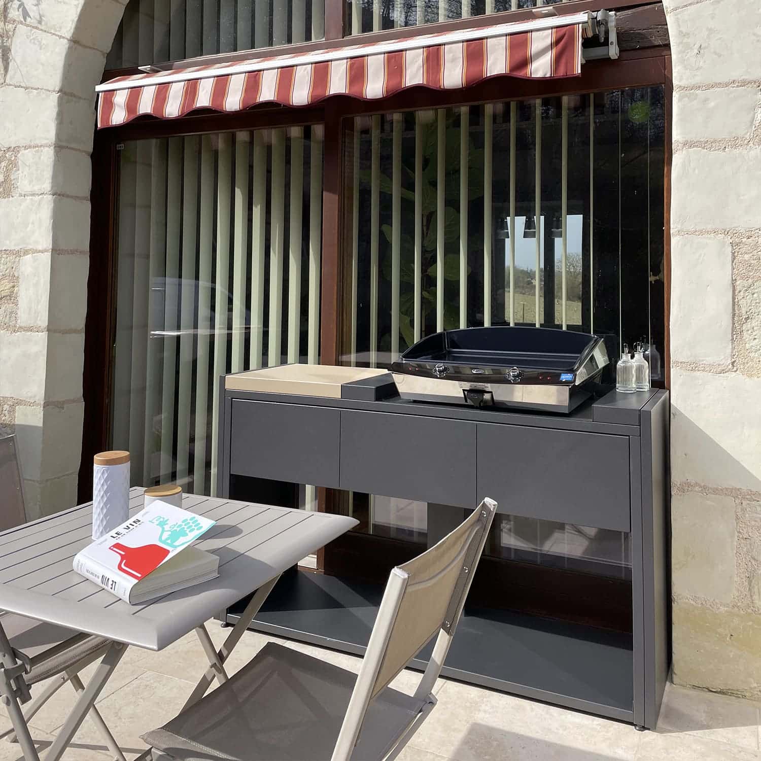 Module de cuisine extérieure Soleil Carré avec une plancha sur une terrasse. Disponible chez Inox Passion